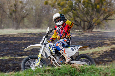 Moscow, Russia - April 13, 2019: Motocross racer on a cross-country motorcycle rushing on a turn....