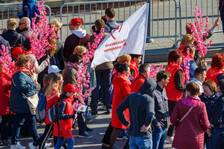 Moscow, Russia - May 01, 2019: Peoples with flag and flowers on Kremlevskaya embankment go to the May Day demonstration on Red Square. May Day celebration in Moscowのeditorial素材