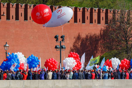 Moscow, Russia - May 01, 2019: Demonstrators with colored balloons on Kremlevskaya embankment...