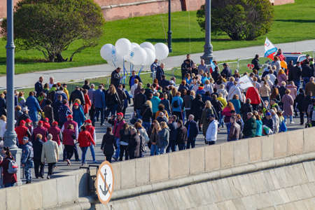 Moscow, Russia - May 01, 2019: Peoples with colored balloons and flags on Kremlevskaya embankment of Moskva river. May Day celebration in Moscowのeditorial素材