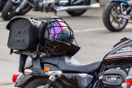 Moscow, Russia - May 04, 2019: Motorcycle helmet on the leather seat of Harley Davidson motorcycle....