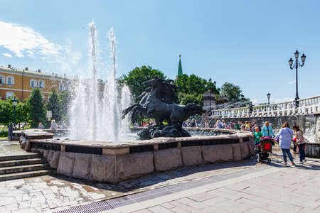 Moscow, Russia - June 02, 2019: Fountain Geyser on Manezhnaya Square in Moscow on a background of Aleksandrovskiy Garden in sunny summer morning against blue skyのeditorial素材