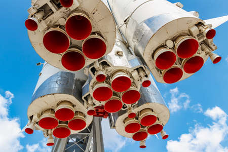 Moscow, Russia - July 22, 2019: Red painted nozzles of jet engines of soviet space rocket Vostok in VDNH park in Moscow closeup at sunny summer day against blue sky with white cloudsのeditorial素材