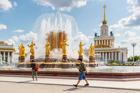Moscow, Russia - July 22, 2019: View of working Friendship of Peoples fountain closeup against pavilions in VDNH park in Moscow at sunny summer dayのeditorial素材