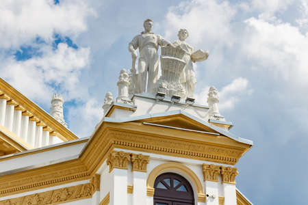 Moscow, Russia - July 22, 2019: Statues on the roof of RSFSR pavilion on VDNH park in Moscow against...