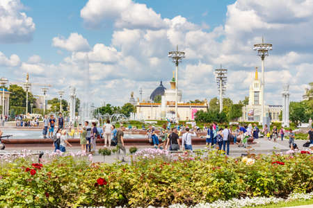 Moscow, Russia - July 22, 2019: Tourists near fountain Friendship of Peoples in VDNH park in Moscow at sunny summer day. VDNH park is popular touristic landmarkのeditorial素材