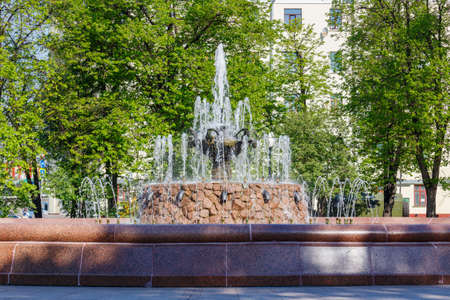 Moscow, Russia - May 07, 2019: Fountain on Bolotnaya square in Moscow at sunny spring morning against green treesのeditorial素材