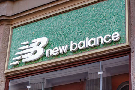 Moscow, Russia - September 13, 2019: New Balance sign on the storefront. Signboard of american sportswear manufacturer New Balance on a green backgroundのeditorial素材