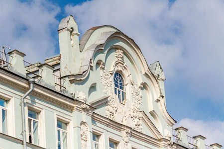 Moscow, Russia - September 13, 2019: Facade of old building on a background of blue sky with white clouds close-up. Architecture of Moscow historical centerのeditorial素材