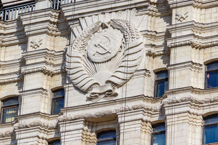 Moscow, Russia - September 21, 2019: Soviet Union coat of arms on the facade of stalin skyscraper in Moscow close-up in sunlightのeditorial素材