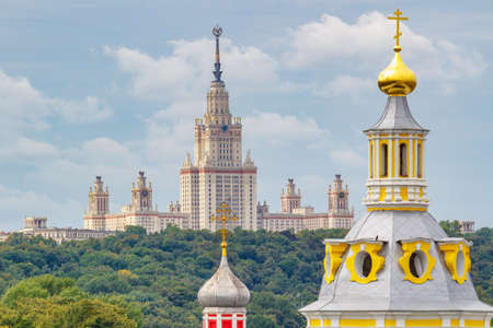 Moscow, Russia - August 13, 2019: Lomonosov Moscow State University building on Sparrow Hills in Moscow against colored domes of orthodox churches at summer morning. Panorama of Moscow famous placesのeditorial素材