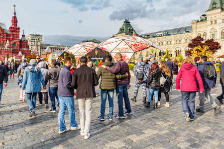 Moscow, Russia - October 05, 2019: Tourists are photographed on Red Square at sunny autumn day....