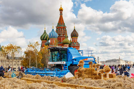 Moscow, Russia - October 08, 2019: Modern combine harvester on Red Square in Moscow against St Basil Cathedral at sunny autumn day. Exposition of traditional festival Golden Autumnのeditorial素材