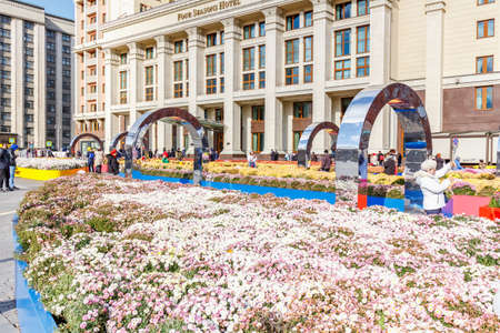 Moscow, Russia - October 08, 2019: Facade of Four Seasons Hotel on Manezhnaya Square in Moscow against decorations of traditional festival Golden Autumn. View in sunny autumn dayのeditorial素材