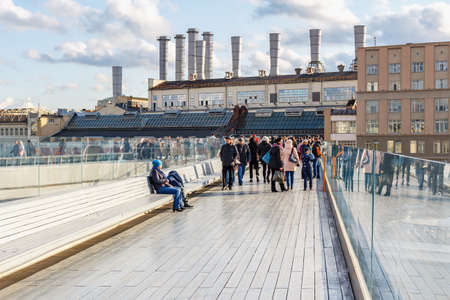 Moscow, Russia - October 08, 2019: Tourists on the Soaring bridge in Zaryadye Park at sunny autumn day. Zaryadye Park is popular touristic place in Moscow downtownのeditorial素材