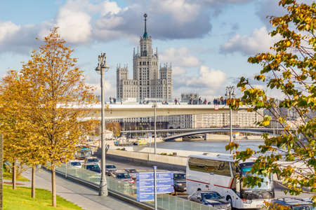 Moscow, Russia - October 08, 2019: Architecture of Moscow historical center. Soaring bridge in Zaryadye Park against stalin skyscraper at sunny autumn dayのeditorial素材