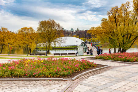 Moscow, Russia - October 16, 2019: View of Podkova Island and pedestrian bridge on the Middle Pond in Tsaritsyno Park in Moscow against decorated flowerbeds on the alleys at cloudy autumn dayのeditorial素材