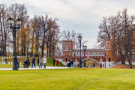 Moscow, Russia - October 16, 2019: People walking on central alley against Figured Bridge in Tsaritsyno Park at sunny autumn day. Tsaritsyno Park is popular touristic landmark in Moscowのeditorial素材