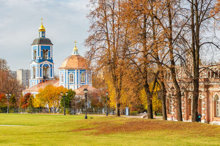 Moscow, Russia - October 16, 2019: Church of Our Lady The Life-Giving Spring in Tsaritsyno Park in Moscow against green lawn and trees with colored leaves in sunny autumn dayのeditorial素材
