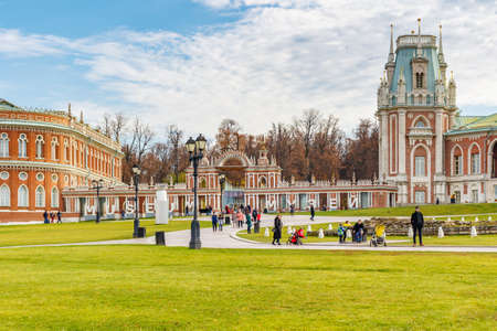 Moscow, Russia - October 16, 2019: Tourists walking on the square in front of Grand Palace in Tsaritsyno Park in Moscow. Tsaritsyno Park landscape in sunny autumn dayのeditorial素材