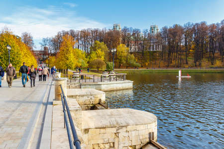 Moscow, Russia - October 16, 2019: People walking on the embankment of Upper Pond in Tsaritsyno Park...