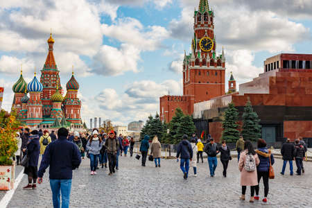 Moscow, Russia - October 08, 2019: Tourists walking along Red square in Moscow against historical buildings in sunny autumn day. Red square is a popular touristic place in Moscow downtownのeditorial素材