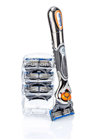 Moscow, Russia - January 23, 2020: Gillette Fusion Proglide Power battery razor handle with attached blade and transparent plastic holder of razor blades standing on white background with reflectionのeditorial素材