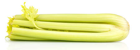 Lying bunch of large celery stems with shadow and reflection on glossy surface isolated on white backgroundの写真素材