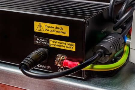 Installed on mounting plate electrical appliance in black metal case connected by black wire to the...