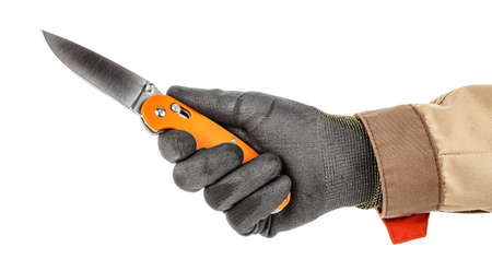 Open pocket folding knife with bright orange handle in worker hand in black protective glove and brown uniform isolated on white backgroundの写真素材