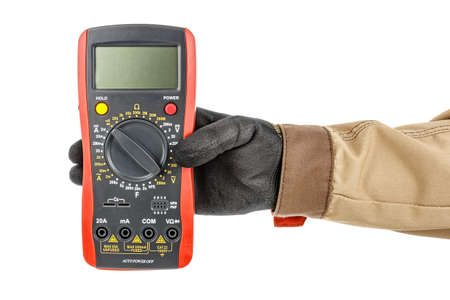 Front view of large digital multimeter with turned off display in electrician hand in black...