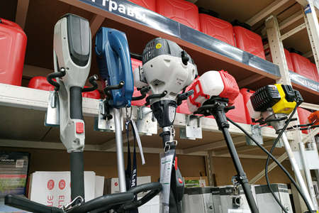 Moscow, Russia - August 17, 2019: Various garden trimmers on the stand in a building materials...