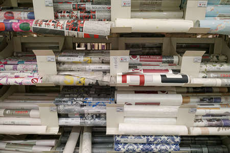 Moscow, Russia - August 17, 2019: Different wallpapers on the rack in a building materials...