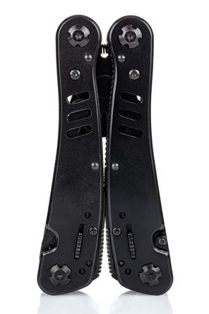 Vertical standing on handles closed black multi tool knife close-up isolated on white background