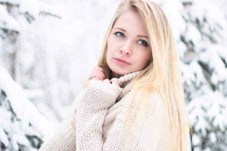 a portrait of a beautiful blonde in the winterの写真素材