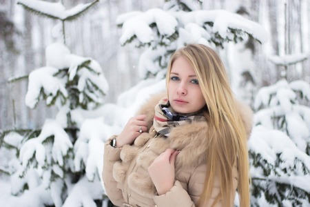 a portrait of a beautiful blonde in the winterの写真素材