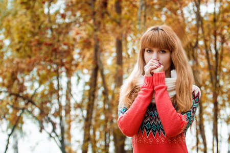 Beautiful young woman - a colorful autumn portraitの写真素材