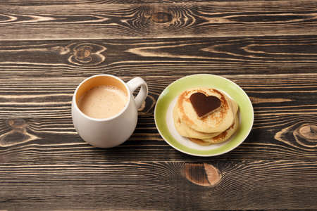 stack of pancakes with on brown wooden board, heart-shaped, Shrove Tuesday, Valentines Day