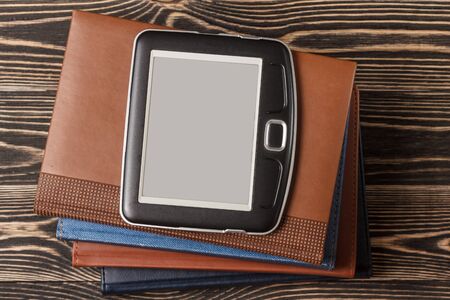 E-book reader close-up on a wooden background