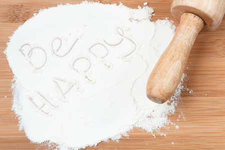 be happy on white flour. wooden table. Flat lay.の写真素材