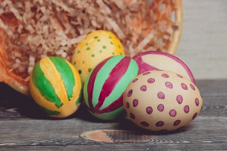 Colorful Easter Eggs on Brown Wood Board Backgroundの写真素材