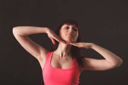 young female dancing jazz over black backgroundの写真素材