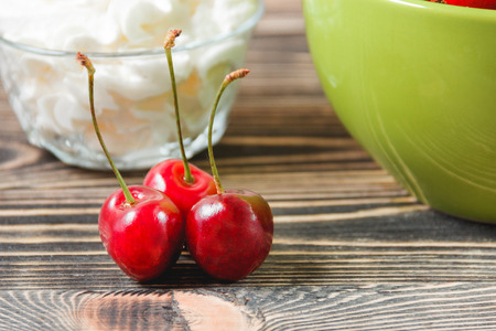 Red Cherries in the Green Cup on Wooden Table, Fruits, Berries Healthy Food Conceptの写真素材