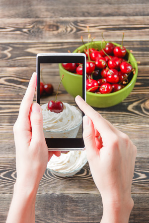 Women Hands Taking Photo Cherry Jam with Smartphone Technology Conceptの写真素材