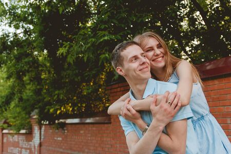 Portrait of Happy Couple Hugging Laughing Outdoor Bricks Wall Background Love Conceptの写真素材