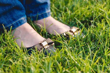 Woman Legs on the Green Grass. Clodeup