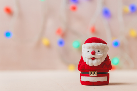 Santa Claus Toy on White Wooden Backdrop. Merry Christmas and Happy New Year Conceptの写真素材
