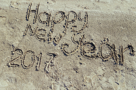 HAPPY NEW YEAR 2017 inscription written on sandy beach. new year conceptの写真素材
