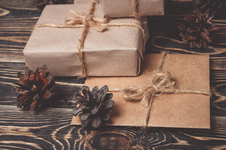 Classy Christmas gifts box presents on brown wooden background. Christmas and Happy New Year...