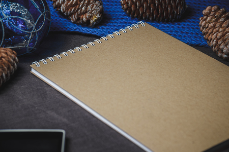 view of notebook in the center of cute blue Christmas decoration, conesの写真素材